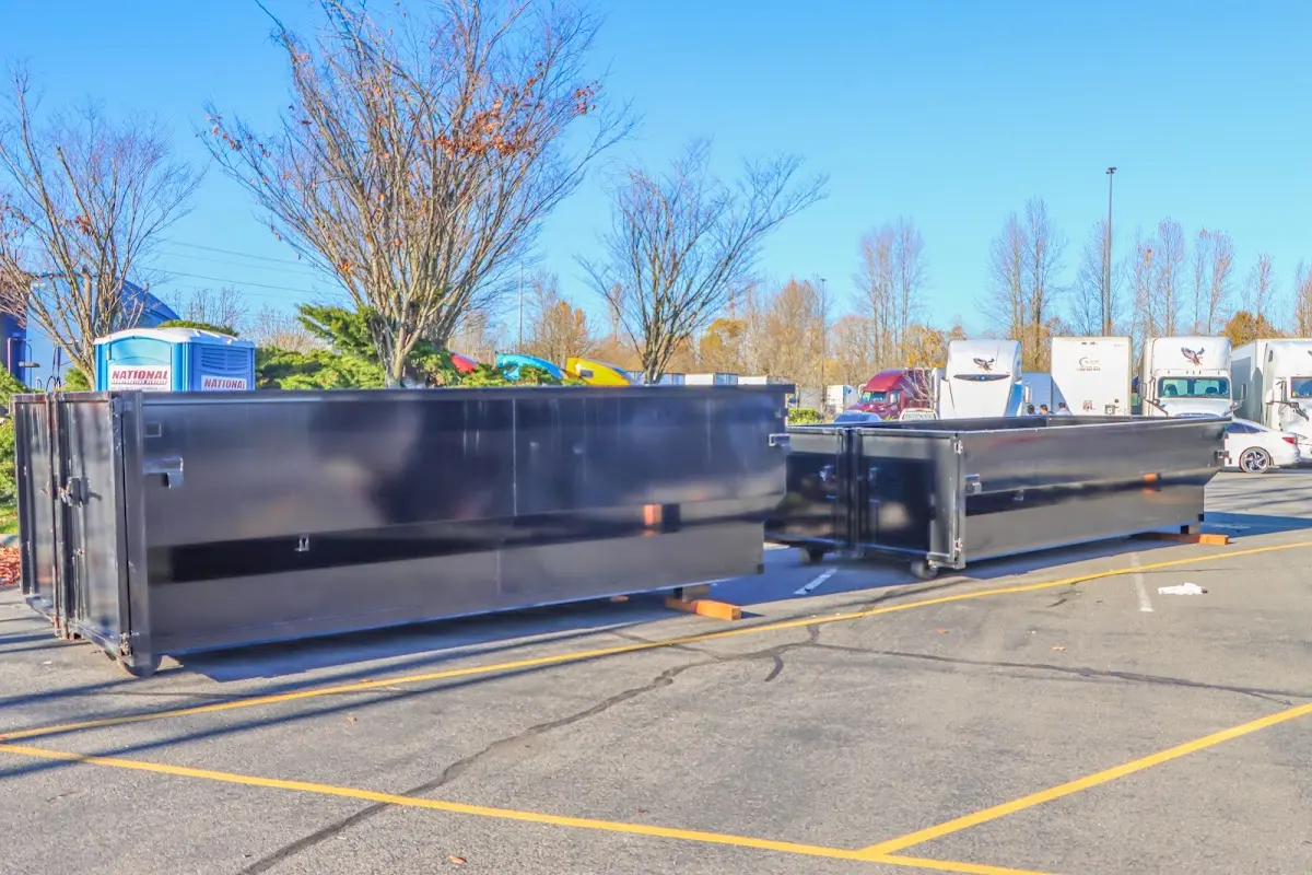 Professional dumpster rental service with roll-off container on residential driveway in Cottage Lake